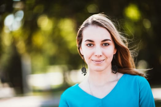 Portrait of a young woman on a blurred background.