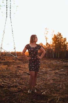 portrait of a beautiful girl in a field on a sunset background.