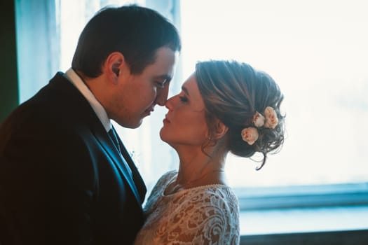 couple groom and bride in light studio.