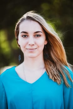 Portrait of a young woman on a blurred background.