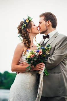 young couple in the style of provence on background of river.