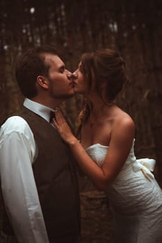 bride and groom in the forest of firs.