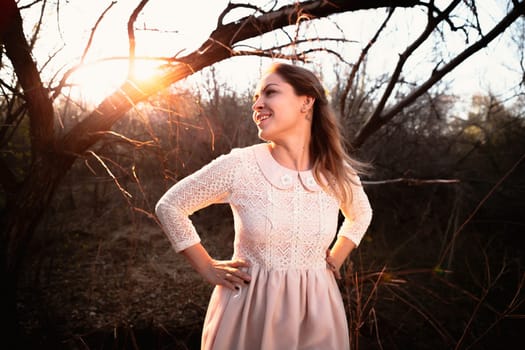 portrait of a girl in a field on a sunset background.