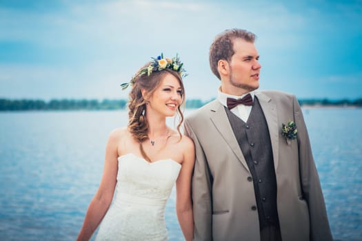 young couple in the style of provence on background of river.