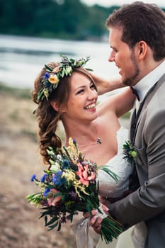young couple in the style of provence on background of river.