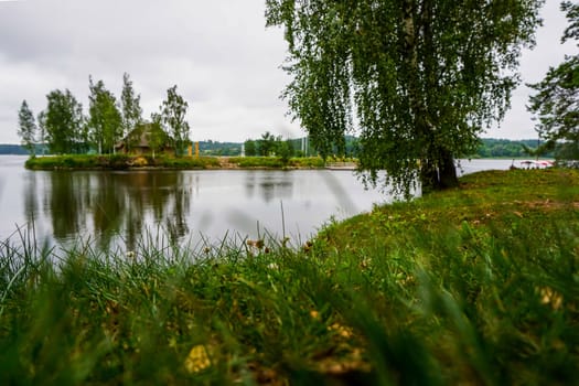 Daugava River near Koknese. Island with sauna in Daugava river. Landscape with birch at Daugava coast. Classical Latvian landscape. Latvian countryside. View of little island in river Daugava, Latvia.