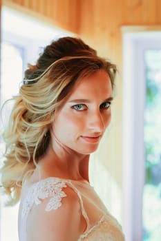 Beautiful young bride on blurred background.