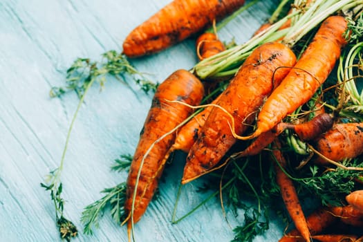lot of carrots on a wooden background.