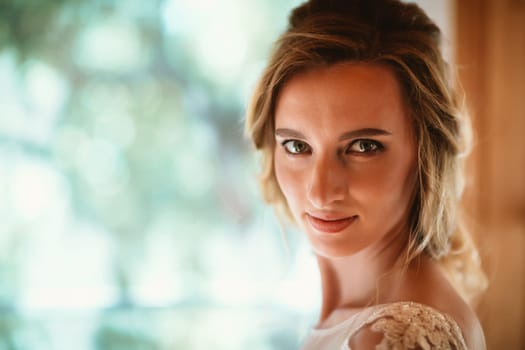 Beautiful young bride on blurred background.