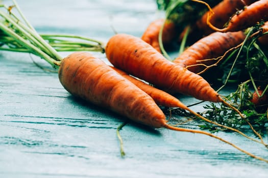 lot of carrots on a wooden background.