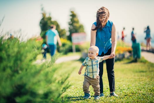 happy mother and toddler son on nature background.