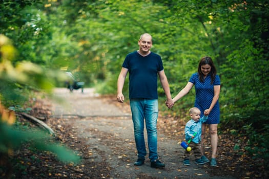 happy family with son on background forest