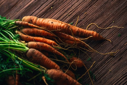 Fresh carrots from the garden close-up on a wooden background.