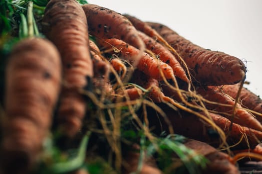 Fresh carrots close-up on a wooden background.