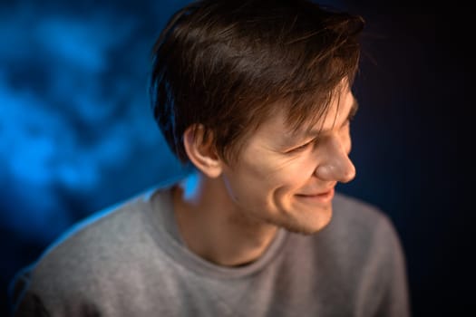 portrait emotional young man on blue background.