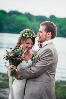 young couple in the style of provence on background of river.