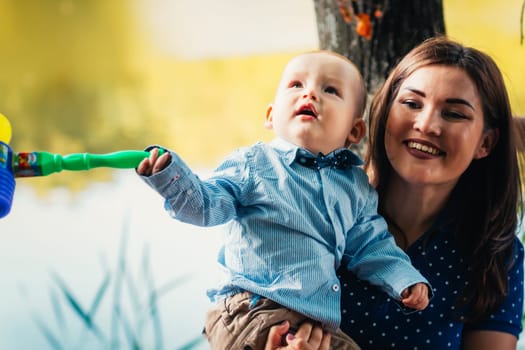 happy mother and toddler son on nature background.