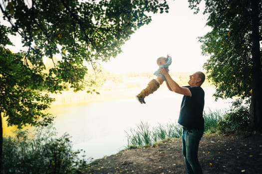 happy dad and baby on nature background.