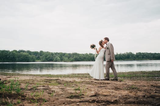 young couple in the style of provence on background of river.