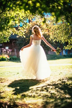 beautiful young bride in the garden background.