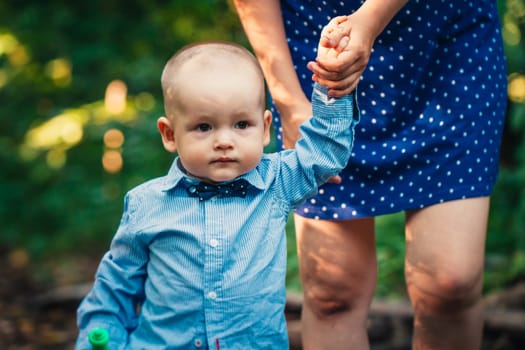 happy mother and toddler son on nature background.