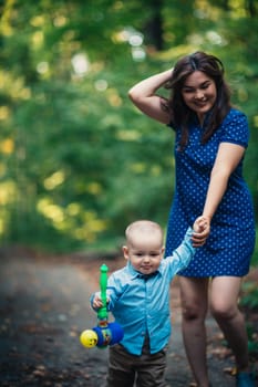 happy mother and toddler son on nature background.