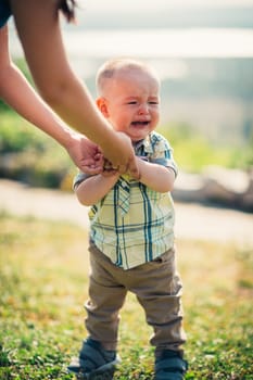 crying toddler baby on nature background.