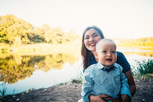 happy mother and toddler son on nature background.