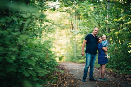 happy family with son on background forest