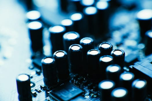 computer board capacitors blue color close up.