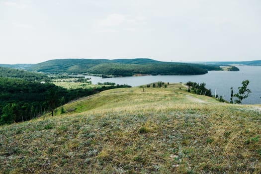 landscape river cliff grass on the sky background.