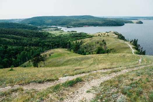 landscape river cliff grass on the sky background.