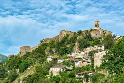 Gjirokaster Castle and clock tower with Ottoman houses below in Gjirokaster, Albania