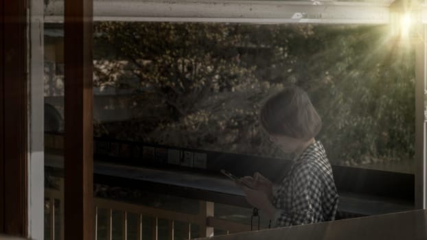 The Girl pointing finger on screen smartphone on background illumination bokeh color light in night atmospheric city