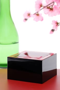 Japanese wooden box masu with sake isolated on white background