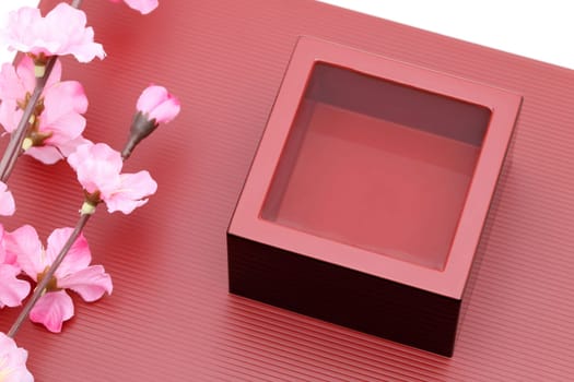Japanese wooden box masu with sake on a wooden plate