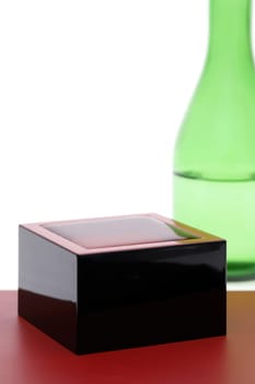 Japanese wooden box masu with sake isolated on white background