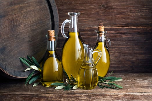 Bottles of Extra virgin healthy Olive oil with barrel background