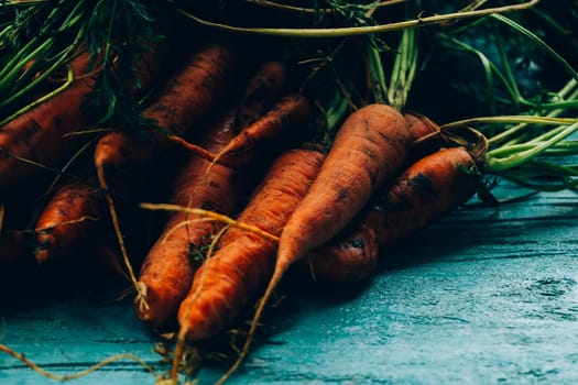 lot of carrots on a wooden background.