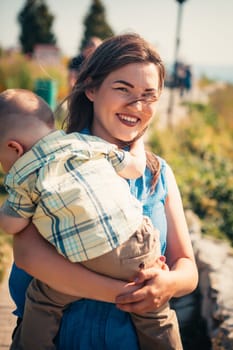 happy mother and toddler son on nature background.