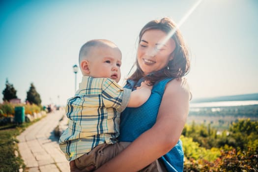 happy mother and toddler son on nature background.