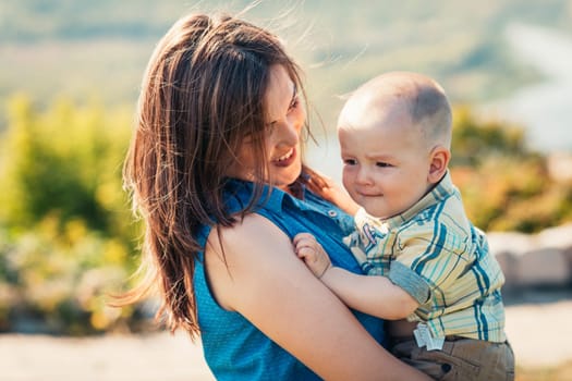 happy mother and toddler son on nature background.