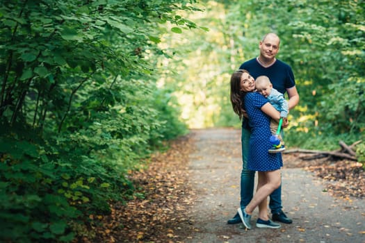 happy family with son on background forest