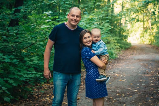 happy family with son on background forest