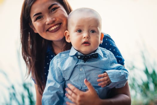 happy mother and toddler son on nature background.