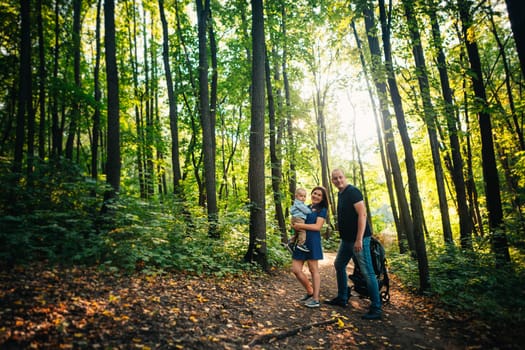 happy family with son on background forest