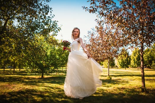 happy young bride on autumn forest background.