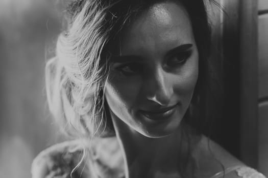black white photo Portrait young beauty bride near the window.