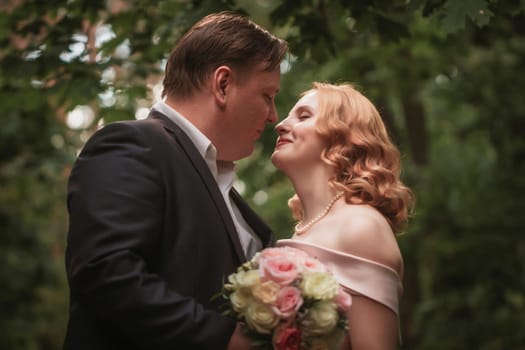 bride and groom dancing in the forest background and sunlight.