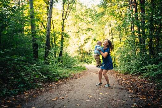 happy mother and toddler son on nature background.